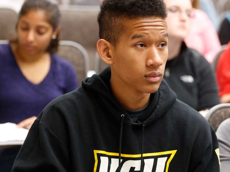 a v.c.u. student listening attentively to a classroom lecture