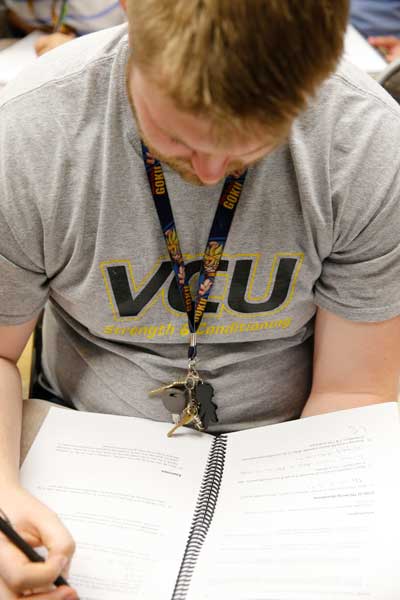 a v.c.u. student studying a notebook